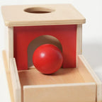 Montessori box on the topic of object permanence