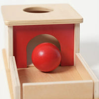 Montessori box on the topic of object permanence