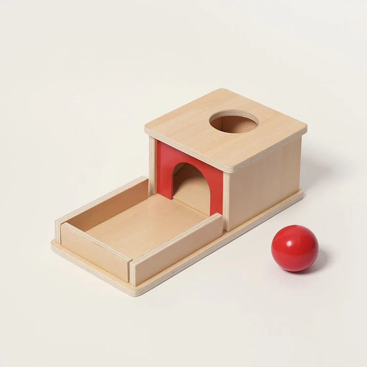 Montessori box on the topic of object permanence