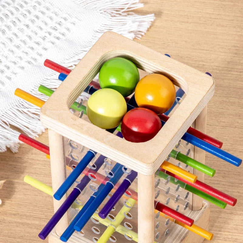 Montessori tower with balls and colorful sticks