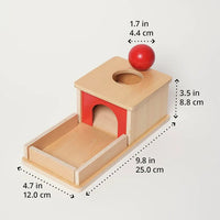 Montessori box on the topic of object permanence